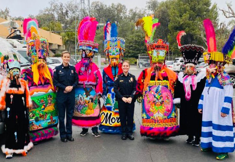 Chinelo dancers with police officers